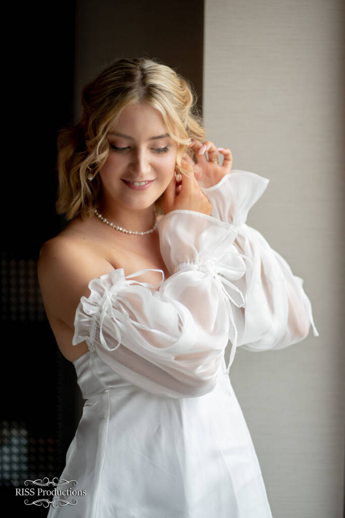 The Bride Fixes Her Jewels With Poise
