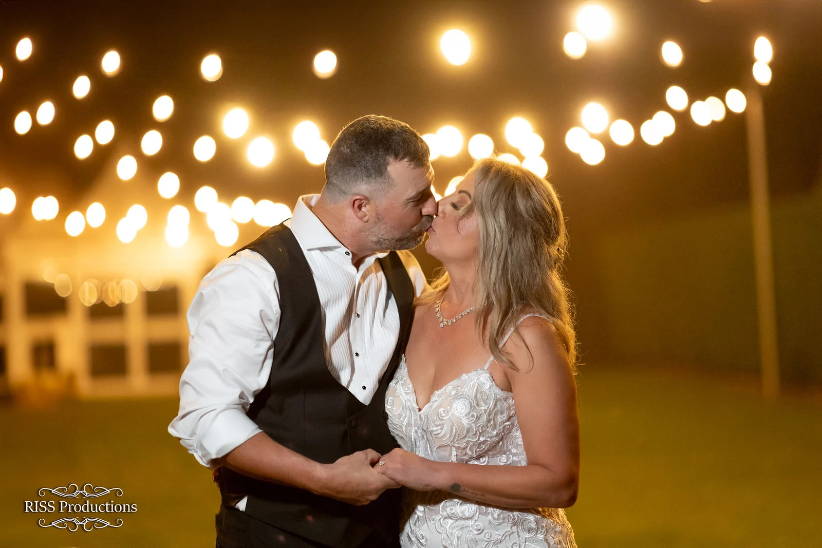 Affy and Glen kissing under festoon lights at Fitzroy Inn, Mittagong