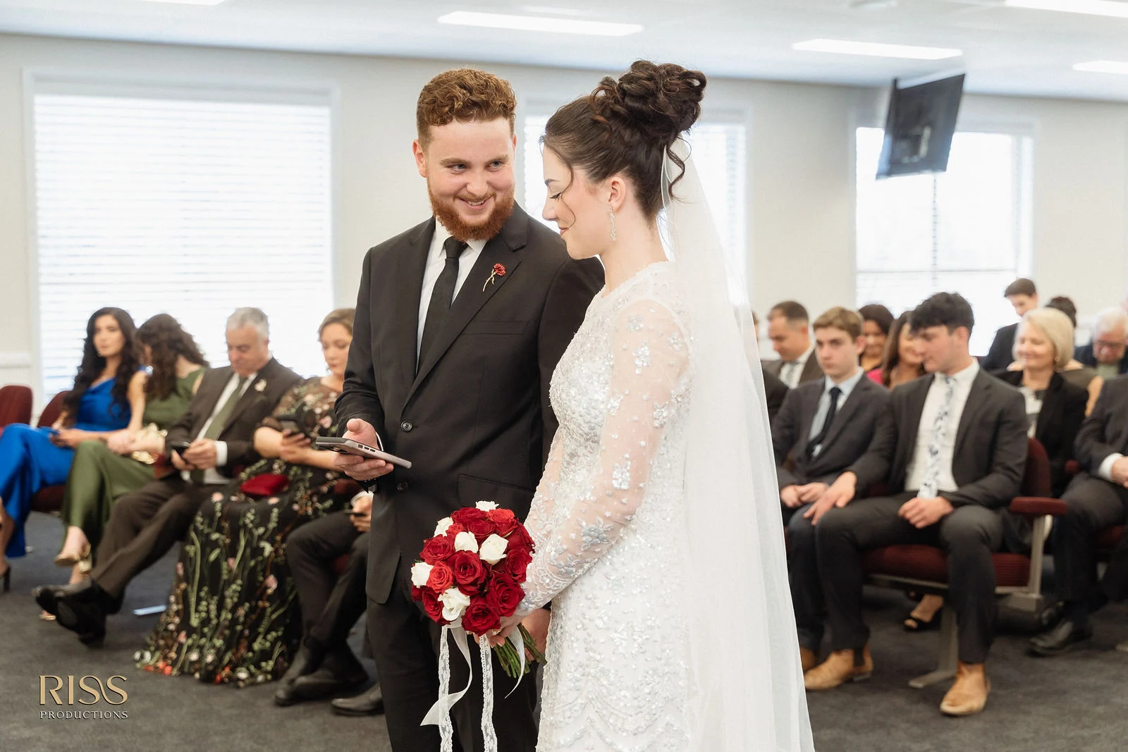 Boe and Jeremy smiling during their wedding ceremony at The Robertson Hotel