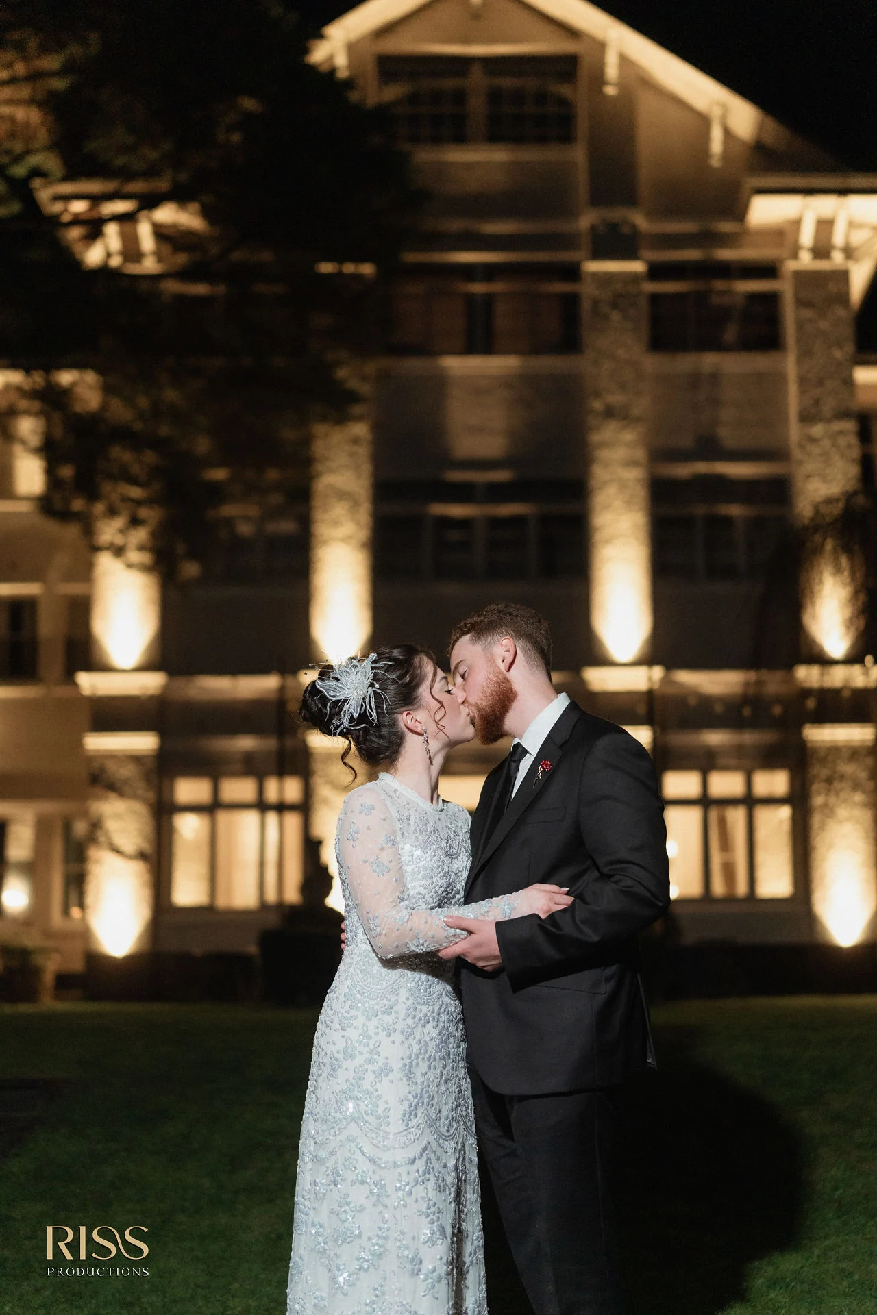 Boe and Jeremy kissing at night outside the illuminated Robertson Hotel