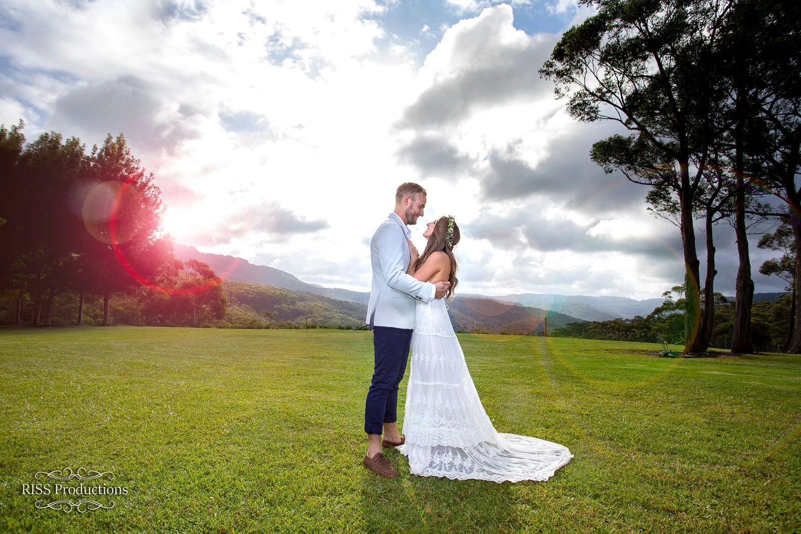 Brooke and Ben in an open field with sun flare in the Blue Mountains