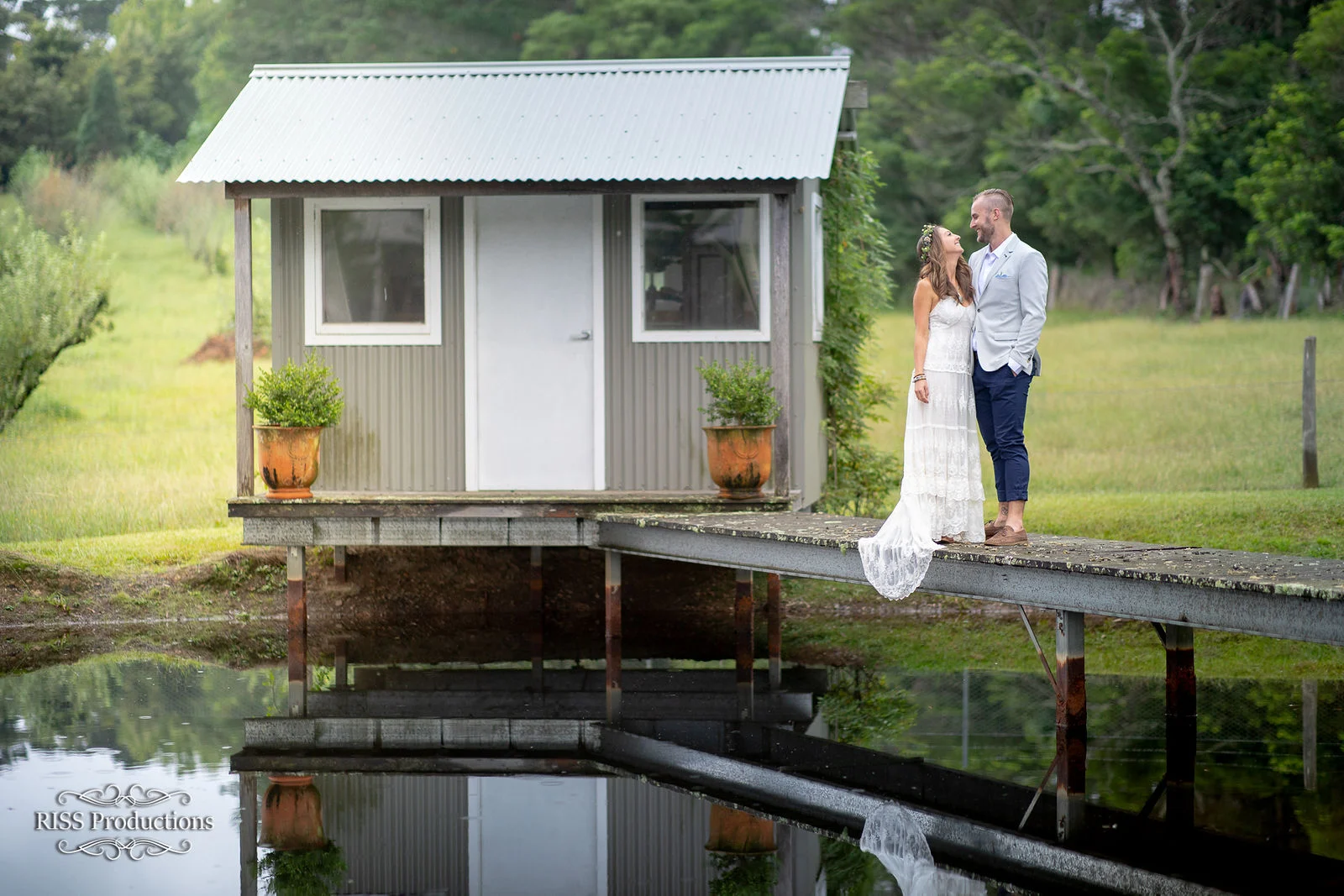 Brooke and Ben by a lakeside cottage in the Blue Mountains
