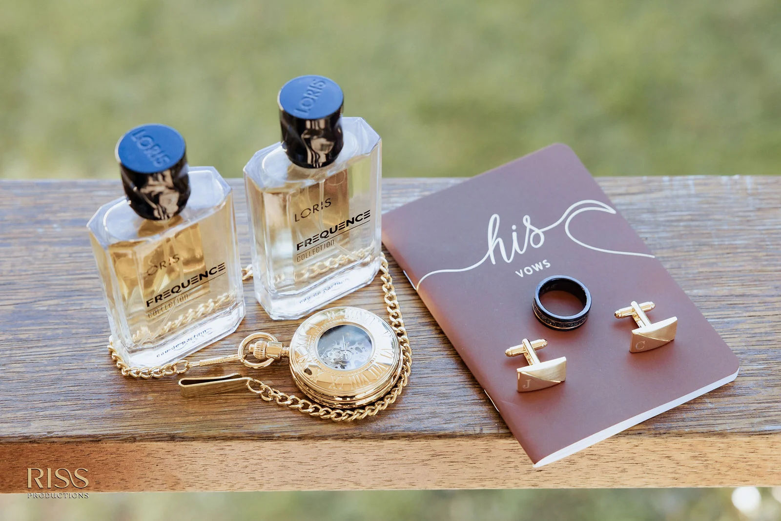Wedding day details with rings, cufflinks and fragrance