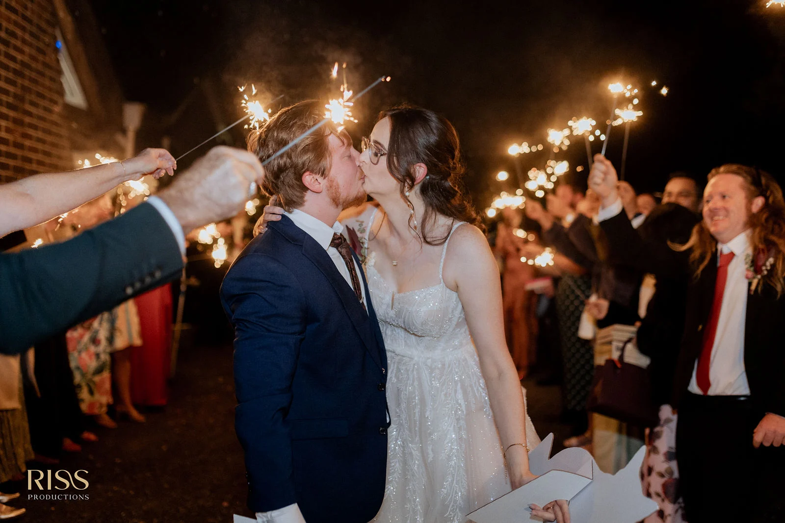 Caitlin and Jakub kissing during a sparkler send-off at Robertson Public House