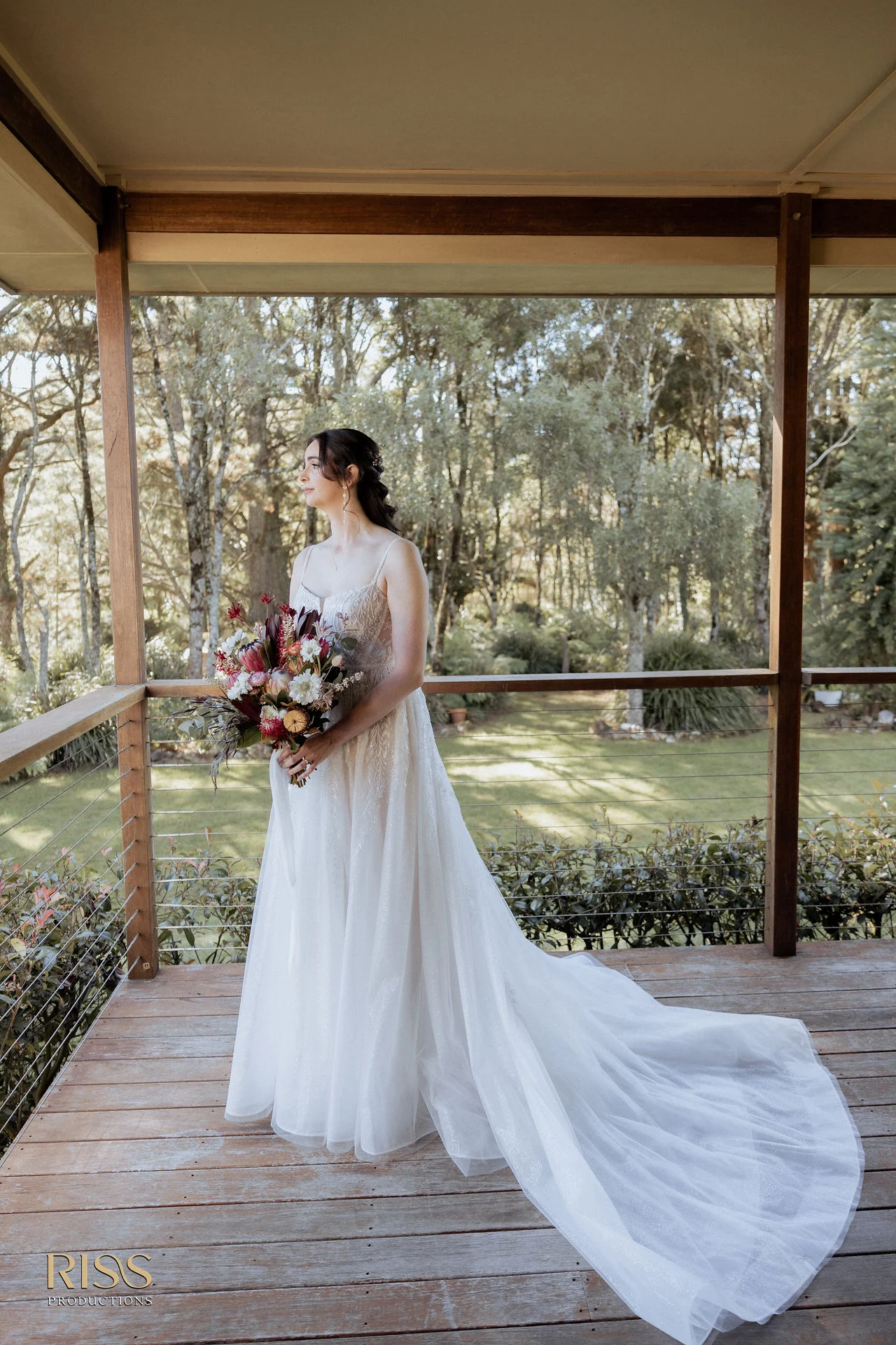 Bride Caitlin in her wedding gown on a verandah, Southern Highlands wedding photography
