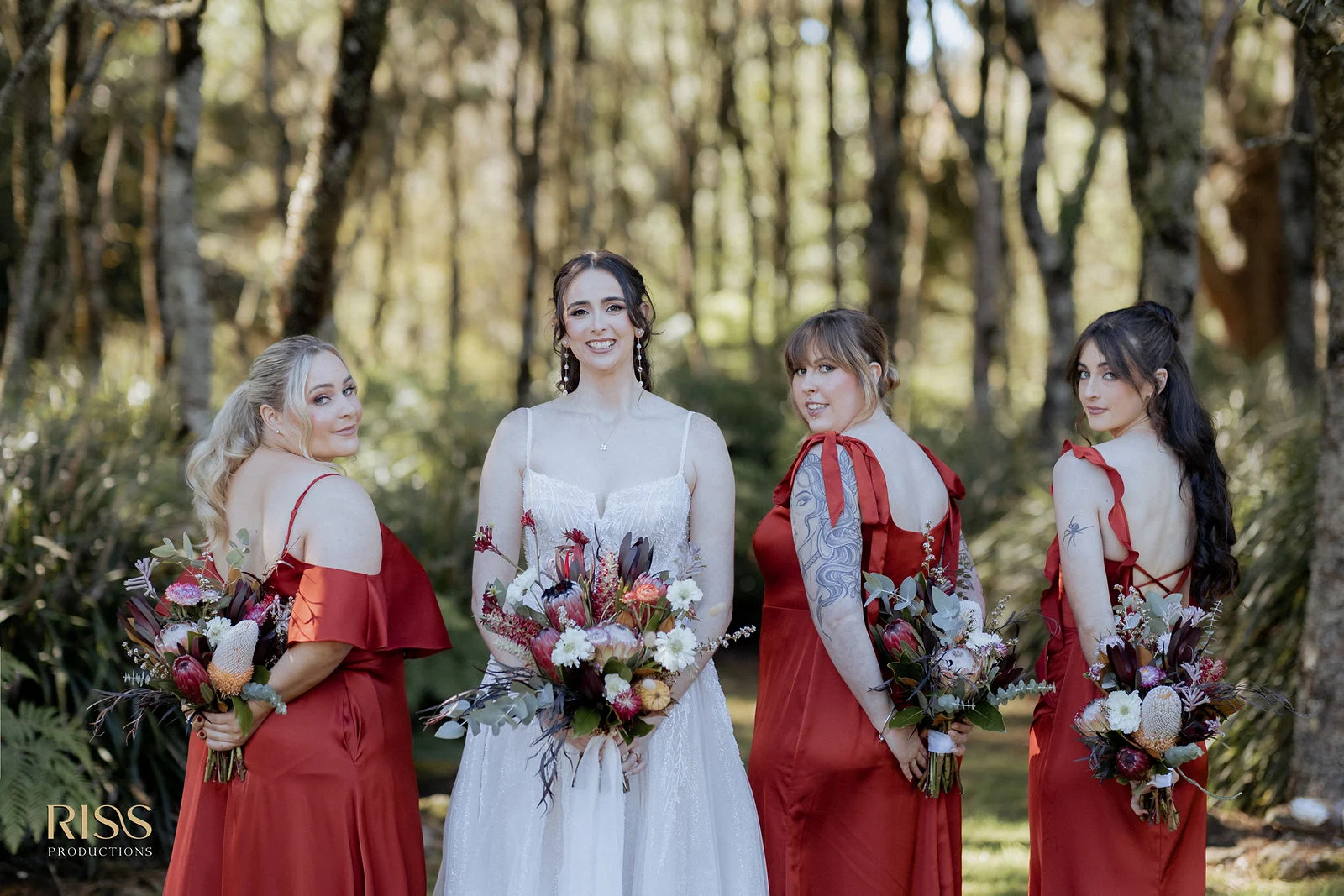 Bride with her bridesmaids in red among the trees, Southern Highlands wedding