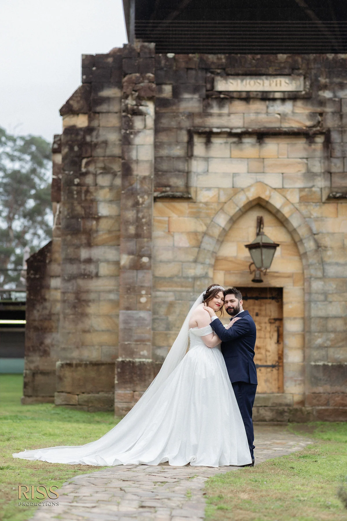 Erin and Michael outside the sandstone chapel at St Joseph's Guest House