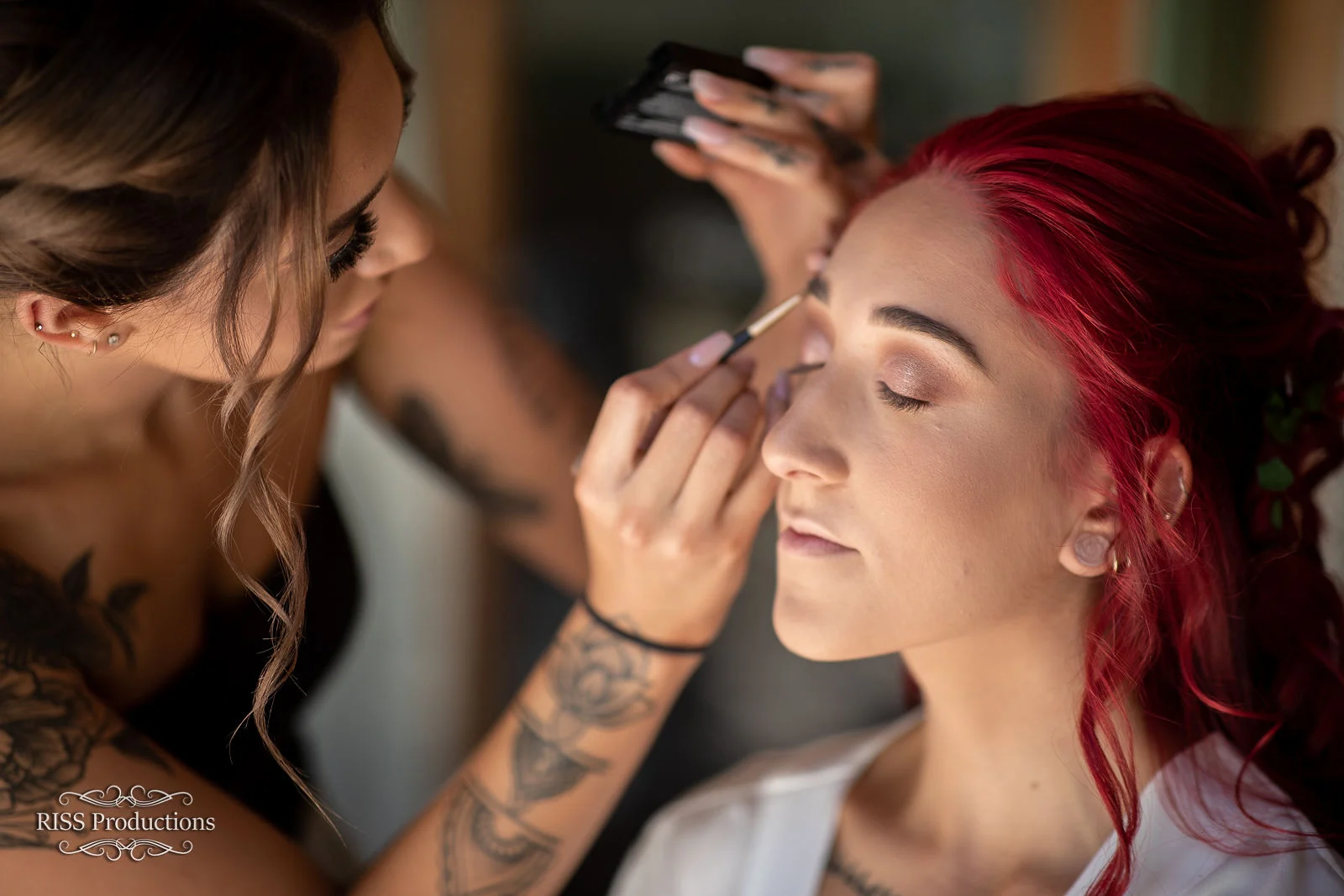 Bride Giacinta having her makeup done on her wedding morning