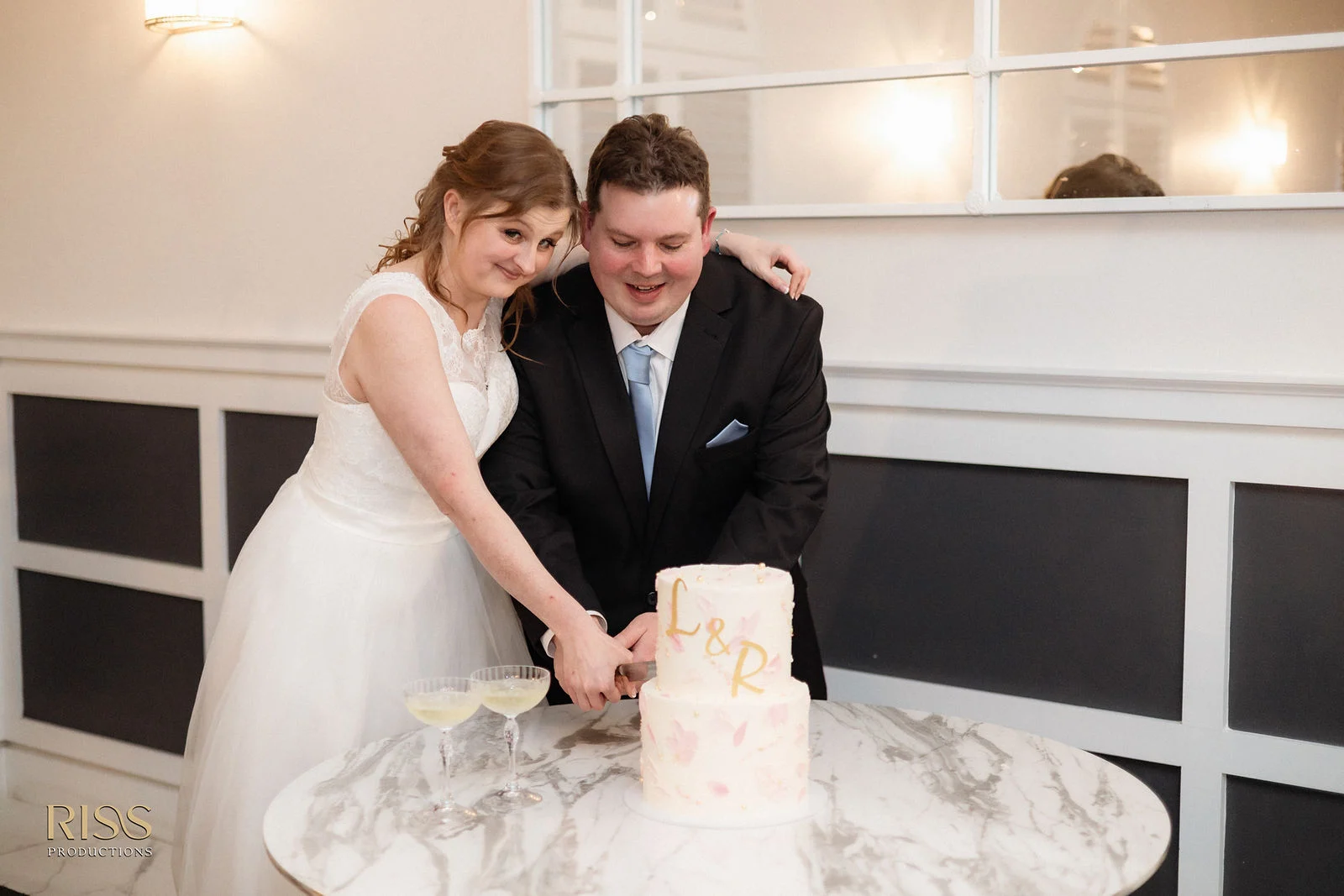 Lauren and Ryan cutting their wedding cake at The Olive Grove
