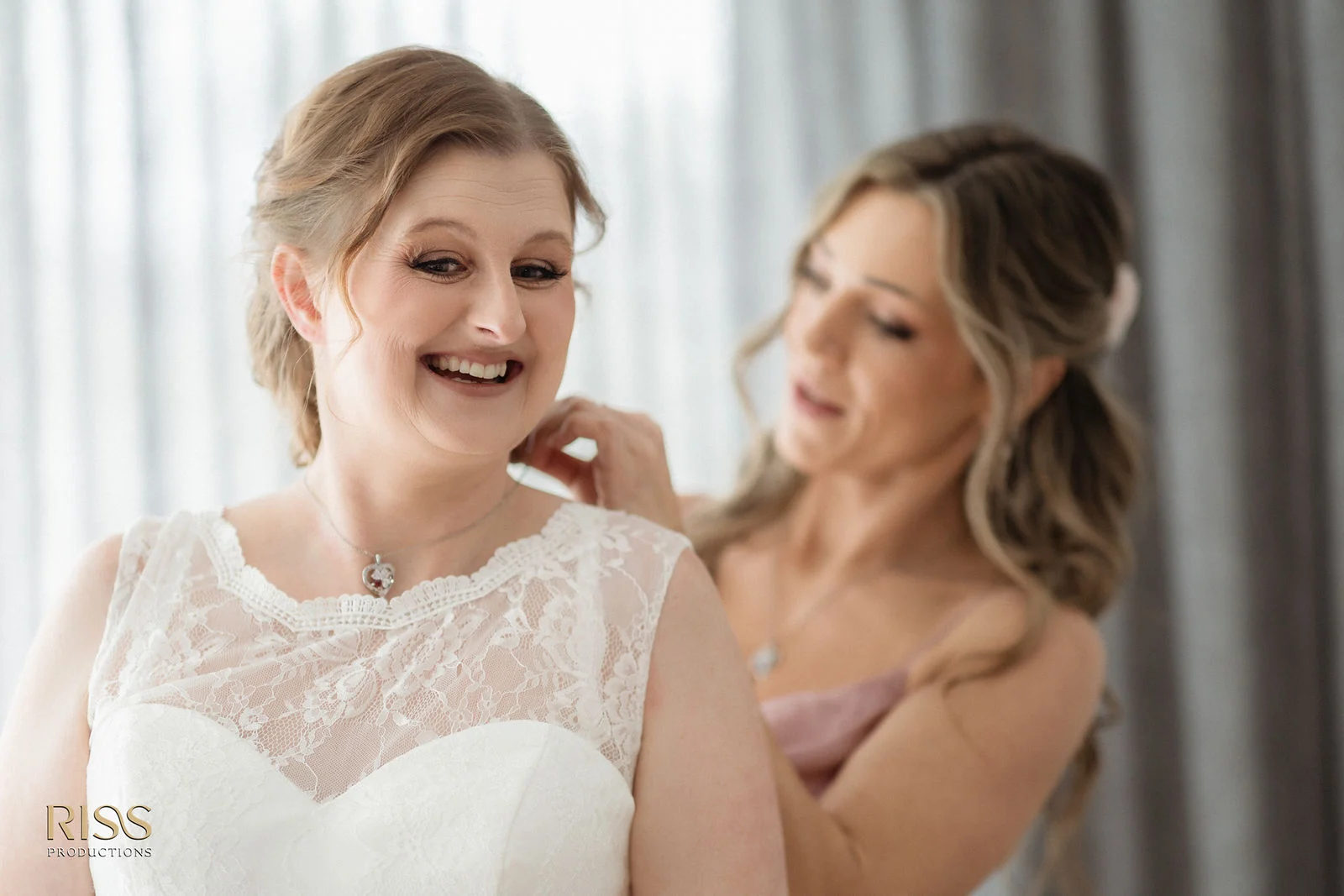 Bride Lauren getting ready with her bridesmaid at The Olive Grove