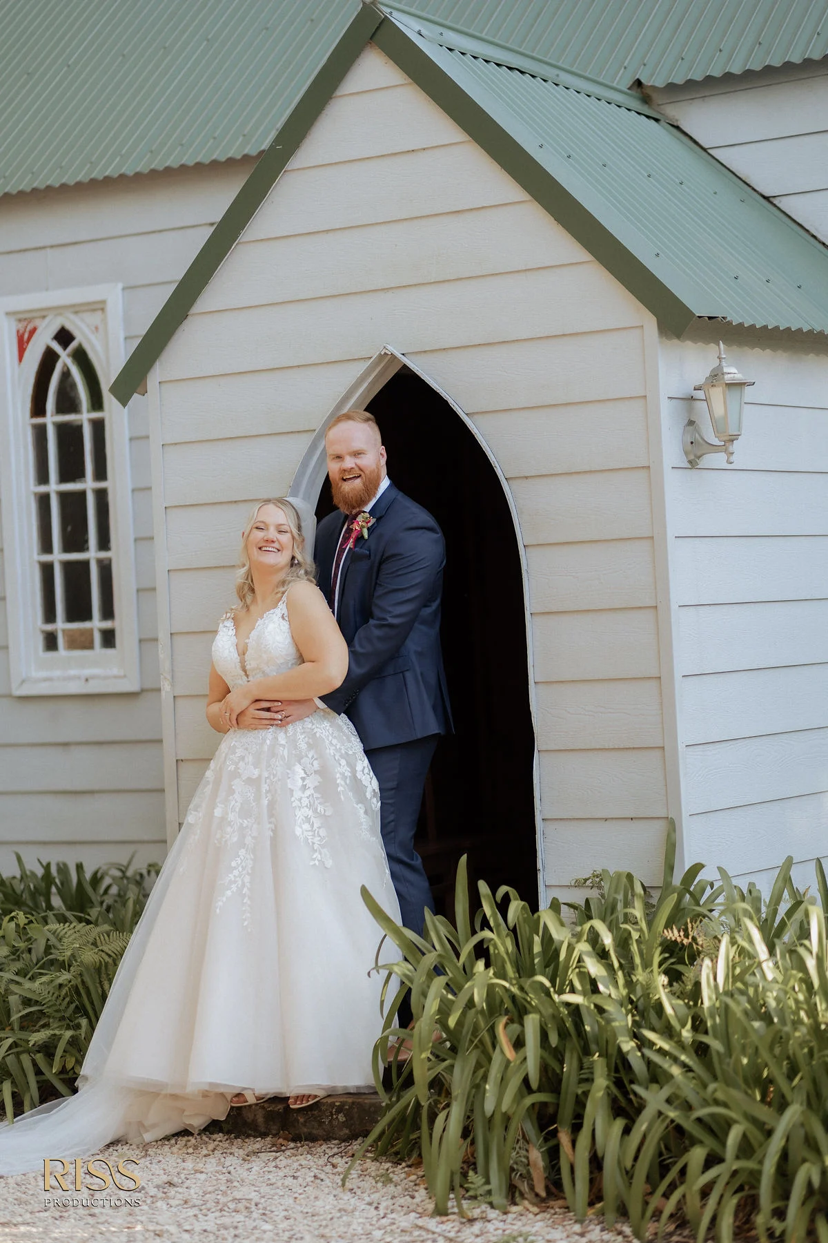 Tamara and Callan outside the white chapel at The Linton, Somersby