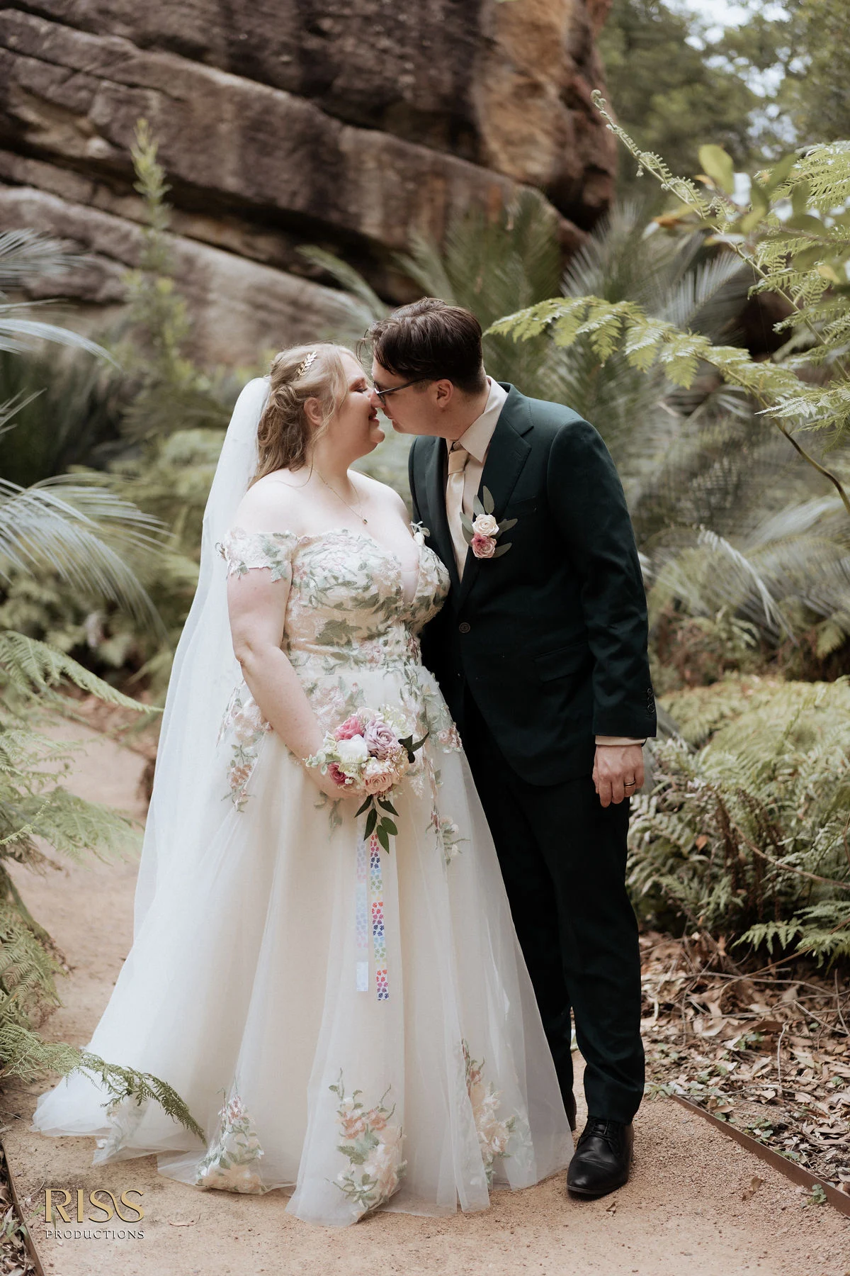 Tiffany and Trent kissing among ferns at Kangaroo Valley Bush Retreat, Southern Highlands wedding
